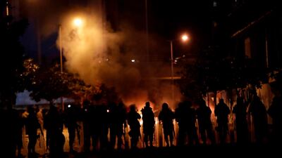 Supporters of Lebanon's Hezbollah and Amal groups clash with security forces late on December 17, 2019 in central Beirut. AFP