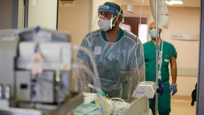 Doctors carry a coronavirus patient in the Intensive Care Unit at Varese’s Circolo hospital. AP Photo