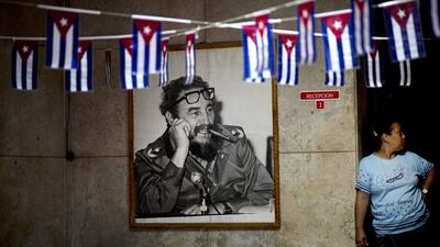 A photograph of Fidel Castro hangs in a municipal building in Havana, on December 26, 2014, where miniature Cuban flags decorate the entrance. Ramon Espinosa/AP Photo