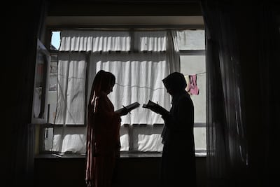 Afghan girls during a lesson given by their father at their home in Kabul. AFP