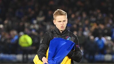 Oleksandr Zinchenko of Manchester City holds a Ukrainian flag. Getty