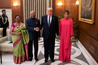 Indian President Ram Nath Kovind and his wife Savita Kovind stand with President Donald Trump and first lady Melania Trump as they arrive for a state banquet at Rashtrapati Bhavan, in New Delhi. Reuters