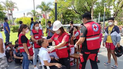 Rescuers attend to an injured resident of Bangued. EPA