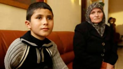 Islam Samouh, a 10-year-old patient, and his aunt, Souad Samouh, arriving in Dubai from a village near Hebron.