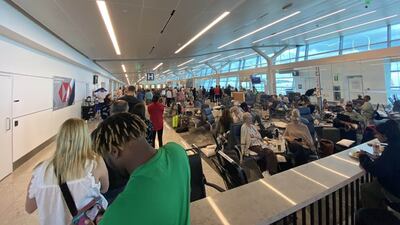Passengers inside the Bermuda airport on Monday after their American Airlines flight from Miami to London had to be diverted. PA