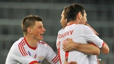 Russia's Alan Dzagoev, right, Alexander Kerzhakov, centre, and captain Andrey Arshavin, left, celebrate after scoring the first goal against Italy in an international friendlly in preparation for Euro 2012. Sebastian Feval / AFP