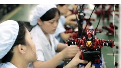 Workers assemble toy robots at the factory of Lung Cheong Toys Limited, owned by Hong Kong-based Lung Cheong International Holdings Limited, in Dongguan, China. Imaginechina