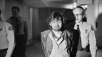 Charles Manson reacts to photographers at trial in 1970. George Brich / AP Photo