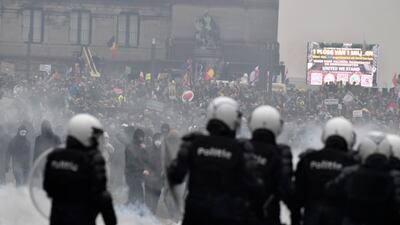 Police use water cannon to push back protesters near the headquarters of the EU in Brussels. AP