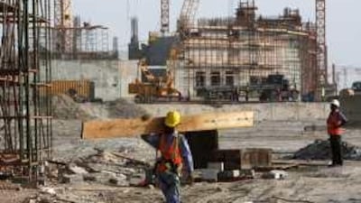 Above, the state of construction on Yas Island last July. Work continues on the racetrack and hotels and other facilities at the site of the Abu Dhabi Grand Prix scheduled for November.