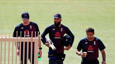 England's Moeen Ali, center, arrives at training. AP