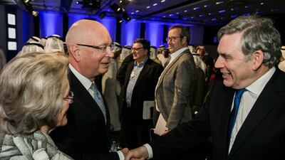 Klaus Schwab, the founder and executive chairman of the World Economic Forum, with former British prime minister Gordon Brown during the opening plenary of the World Economic Forum's Summit on the Global Agenda being held in Abu Dhabi. Courtesy World Economic Forum