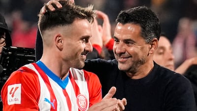 Girona's head coach Michel celebrates with Aleix Garcia after they beat Atletico Madrid 4-3. EPA