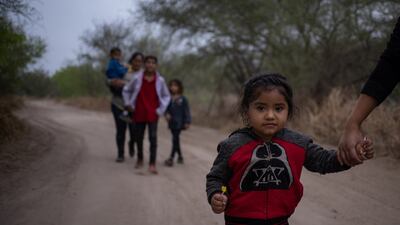 A three-year-old asylum seeker from Honduras holds her mother’s hand after crossing the Rio Grande into the US from Mexico. Reuters