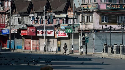 In this file photo taken on September 8, 2019 an Indian paramilitary trooper patrols along an empty street during a strict curfew in Srinagar. AFP