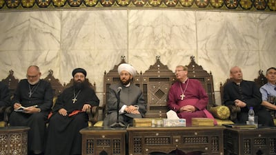 Reverend Andrew Ashdown, left, and Michael Langrish, Former Bishop of Exeter, sit alongside the Grand Mufti of Syria who is believed to be responsible for authorising the executions of thousands of Syrian prisoners. Gareth Browne / The National