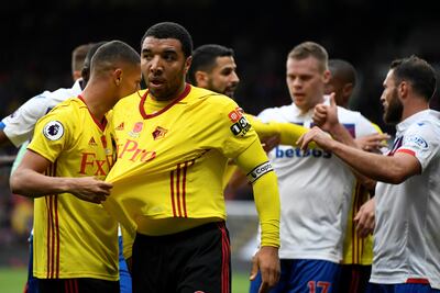 Watford's Troy Deeney, centre, is pulled away by Richarlison after an altercation with Stoke City midfielder Joe Allen. Tony O'Brien / Reuters