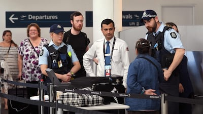 Police help screen passengers at Sydney Airport on July 30. Australia foiled an ISIL-inspired terror plot on an Etihad flight. William West / AFP Photo