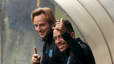 Barcelona’s Ivan Rakitic and Adriano Correia arrive for a training session. REUTERS/Albert Gea