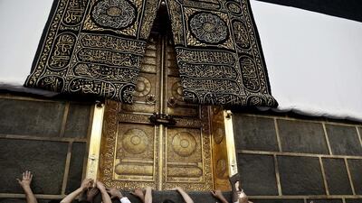 Muslim pilgrims touch the golden door of the Kaaba, Islam’s holiest shrine, at the Grand Mosque in Mecca, Saudi Arabia. Millions of pilgrims have arrived to Mecca ahead of the Haj annual pilgrimage which begins on Saturday. Nariman El-Mofty / AP Photo