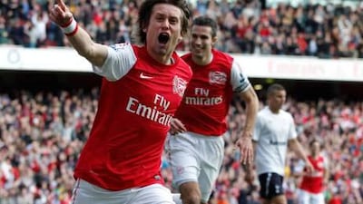 Tomas Rosicky, left, and Robin van Persie celebrate Arsenal’s third goal against Tottenham in London on Sunday.