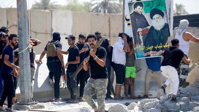 Members of Saraya Al Salam, affiliated with Moqtada Al Sadr, clash with Iraqi security forces in Baghdad's Green Zone on Tuesday. AFP