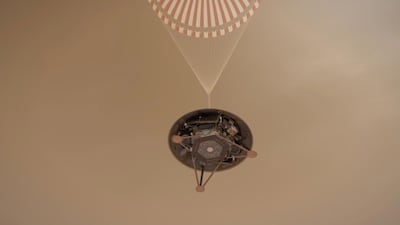 An illustration shows a simulated view of Nasa's InSight lander descending towards the surface of Mars on its parachute. EPA