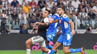 Juventus' Paulo Dybala and Napoli's Kostas Manolas in action. EPA
