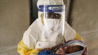 A health worker carries a baby suspected of being infected with Ebola at a hospital in North Kivu Province in the Democratic Republic of Congo. Reuters