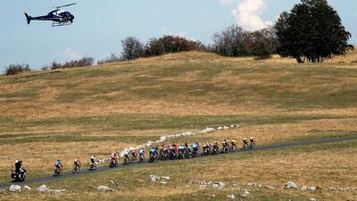 A helicopter flies over the peloton. AP