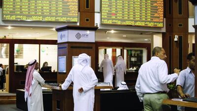 Looking up: traders work on the floor of the Dubai Financial Market this October, during a year when the yellow numbers on the signboards were overwhelmingly positive. Sarah Dea / The National