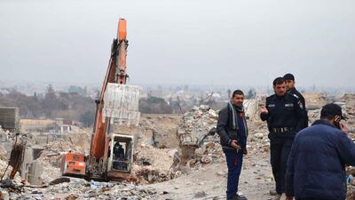 Iraqi men check a site in the city of Mosul where bodies of alleged ISIL fighters remain on January 11, 2018. Ahmad Muwafaq / AFP
