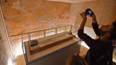 A man takes a picture of the mummy. AFP