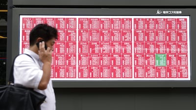 An electronic stock board displayed outside a securities firm in Tokyo, Japan. Bloomberg