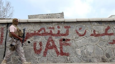 A soldier from the Saudi-led coalition walks on a street pavement in Yemen's southern port city of Aden. Faisal Al Nasser / Reuters