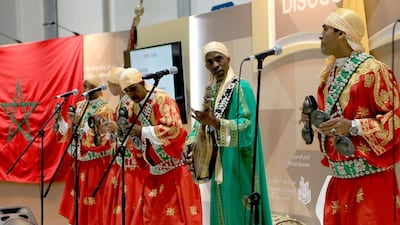 Hassan Boussou (in green) performs with his group at the Abu Dhabi International Book Fair. Ravindranath K / The National