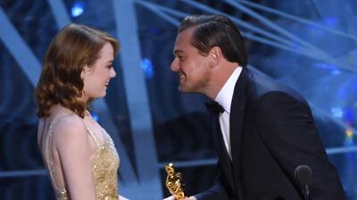 Leonardo DiCaprio, right, presents Emma Stone with the award for best actress in a leading role for La La Land at the Oscars 2017. Chris Pizzello / Invision / AP