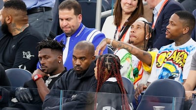 From left, Antonio Brown, Ye and North West among the spectators. Getty Images