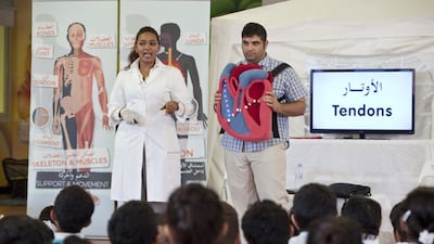 Hiba Salaheldin and Ahmed Abu Ali teach the Lema Bodybuilders programme to pupils at Al Ittihad School in Khalifa City A. Antonie Robertson/The National