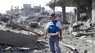 Ashraf al Masri , an assistant to the foreign media working in Gaza stands amongst the rubble of his home after seeing that the Israeli military destroyed his three story home in Beit Hanoun to rubble July 26,2014. Six homes belonging to the al Masri home were heavily damaged and three of them were totally destroyed . Sixty family members have been taking shelter in one apartment in Gaza City and now have no home to return to once the war is over. Heidi Levine for The National