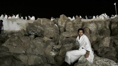A Muslim pilgrim rests on the Mountain of Mercy. Nariman El-Mofty / AP Photo