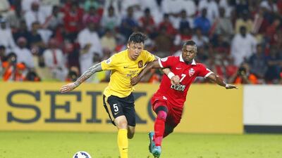 Al Ahli’s Ismail Al Hammadi, right, refused to back down against Guangzhou’s Zhang Linpeng. Al Ittihad