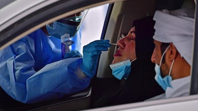 A nurse administers a swab test.