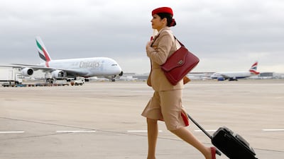 An Emirates air stewardess near one of the airline's Airbus A380 aircraft at Terminal 3 of Heathrow Airport. Bloomberg