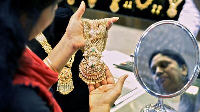 An Indian customer looks at gold jewellery in Bangalore. The government has banned the export of gold above 22 carats. Manjunath Kiran / AFP