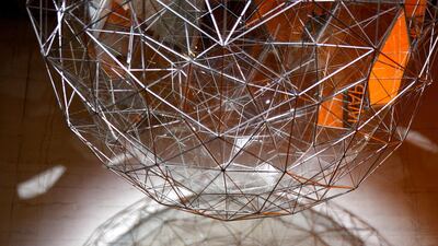 A woman poses with Danish-Icelandic artist Olafur Eliasson's work 'Stardust Particle' (2014) at the Tate Modern in London, Britain, 09 July 2019. Photo: EPA