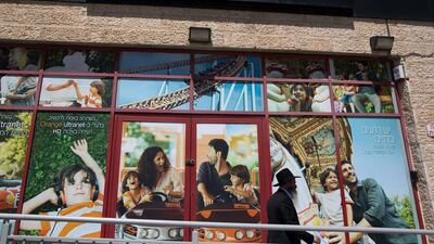An ultra orthodox Jewish man walks past a store of Israeli telecom operator Partner, which has a licence from French company Orange to use its brand, in Jerusalem on June 4. AFP Photo