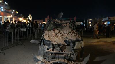 A car lies damaged under fallen rubble from a nearby building in Marrakesh. Getty Images