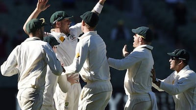 Australian players celebrate after the final wicket against the West Indies on Tuesday. Andy Brownbill / AP / December 29, 2015