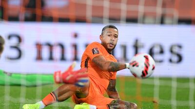 Netherlands forward Memphis Depay slides to slot home the Netherlands' second. AFP